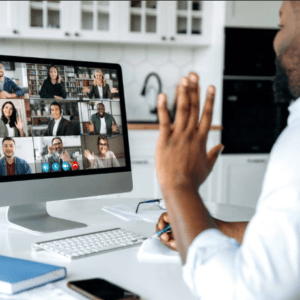 Man sitting at a desk in a video call participating in a scholarship coaching program