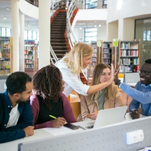 A group of students receiving scholarship coaching from a mentor