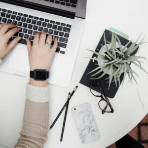 Someone sitting at a desk reviewing scholarship and admission applications